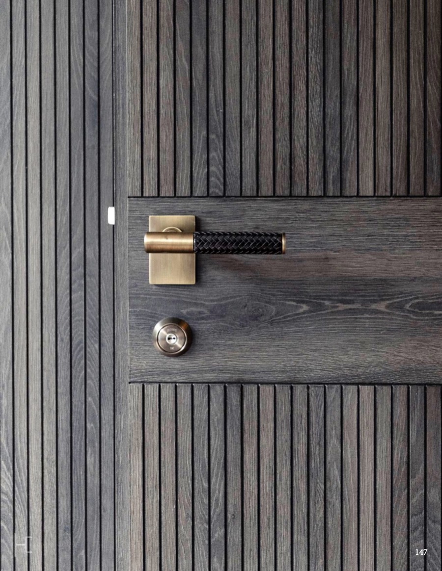 Dark fluted door with a leather wrapped lever handle