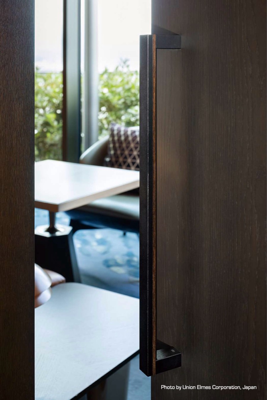 Timber door with a full height dark pull handle